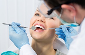 Dentist performing dental checkup to prevent dental emergencies