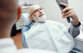 Patient at dentist smiling after root canal therapy in Milton