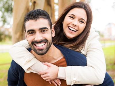 Man and woman with healthy smiles thanks to advanced dental services and technology