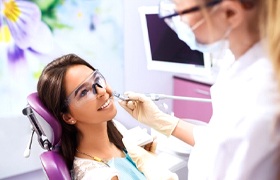 cosmetic dentist in Milton treating a patient