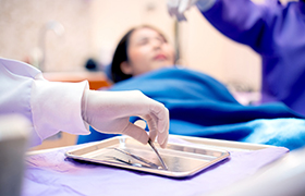 Blurred dentists treating a patient’s dental emergency