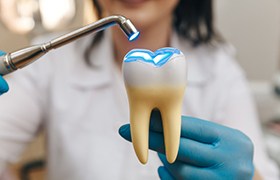 Dentist simulating what curing a tooth looks like