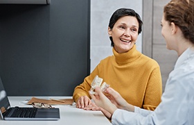 Older woman talking to her dentist