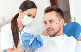 Man at dentist getting Invisalign in Milton