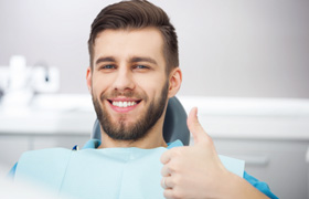 Bearded male dental patient giving thumbs up