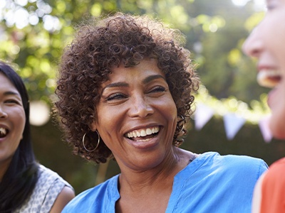 Woman sharing beautiful smile after replacing missing teeth