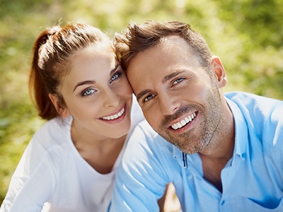 Man and woman smiling after preventive dentistry