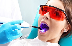 Young woman receiving dental sealants