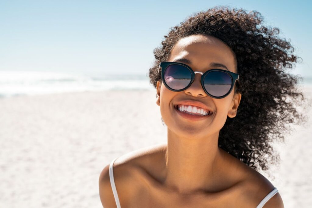 A woman smiling on the beach