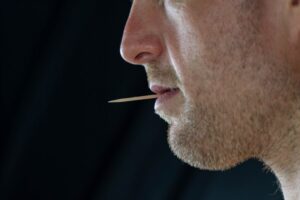 Man with toothpick in his mouth.